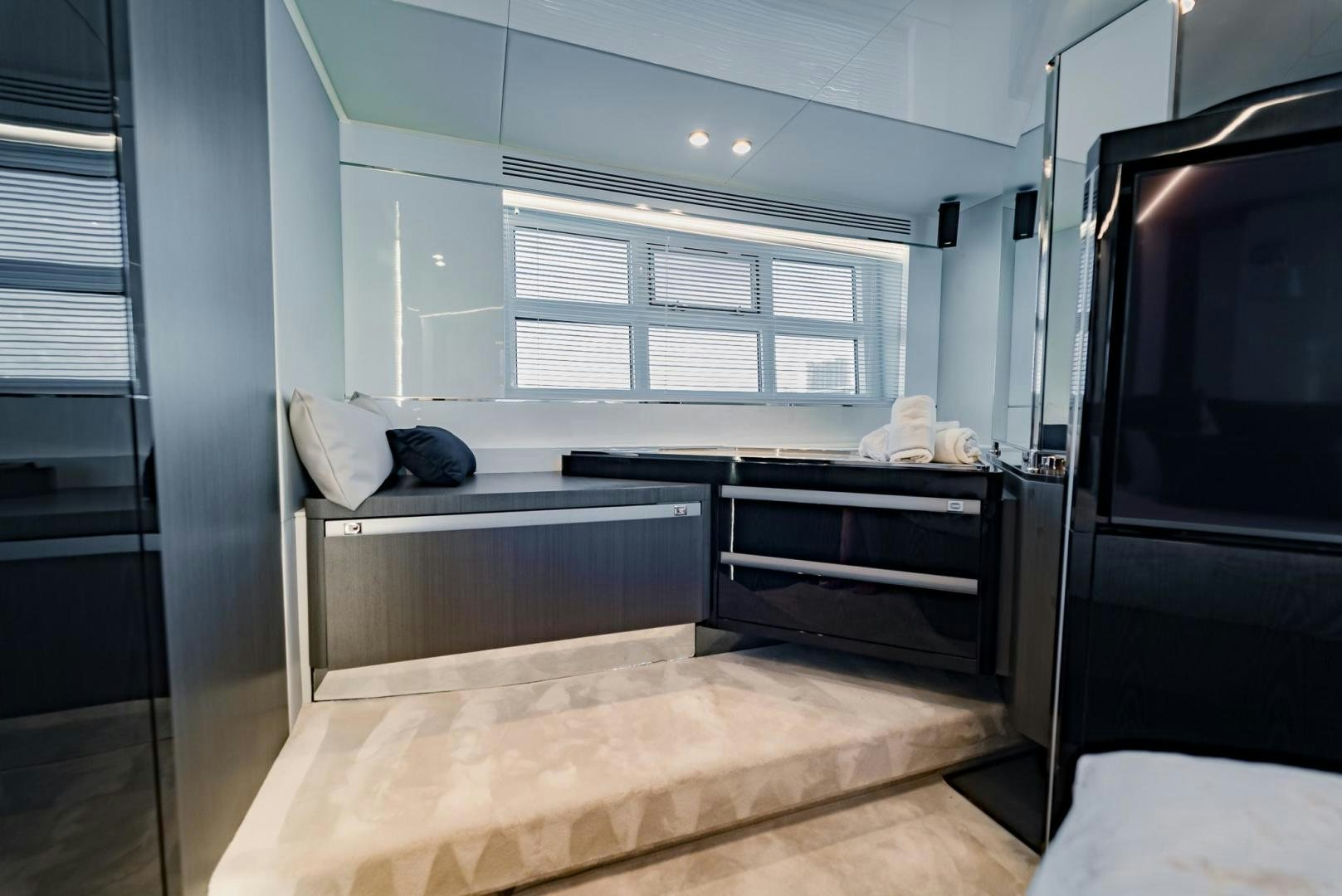 a bedroom with a bed and a desk aboard HOME SOUTH Yacht for Sale