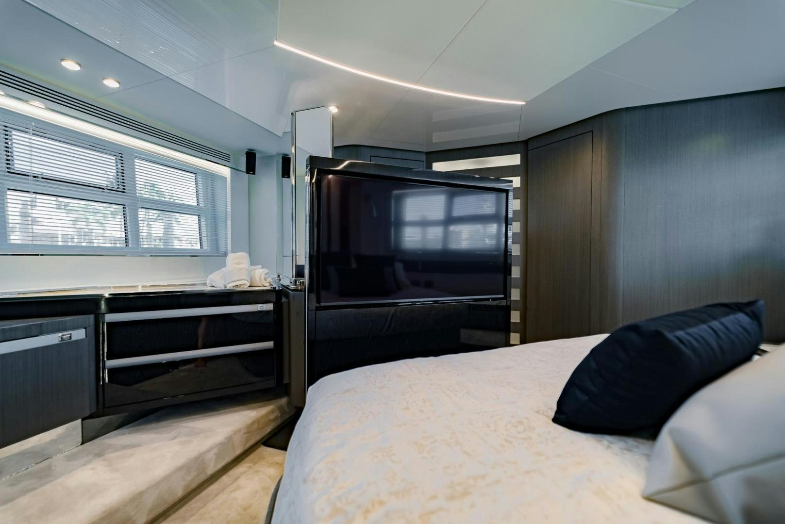 a bedroom with a bed and a tv aboard HOME SOUTH Yacht for Sale