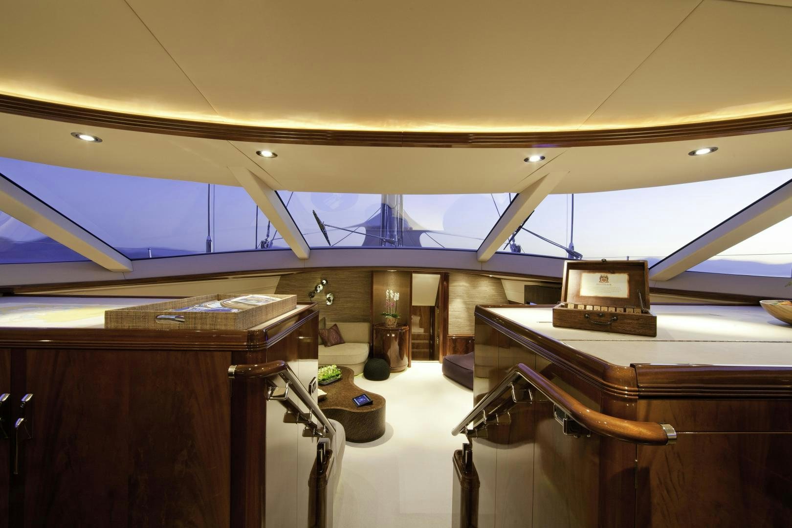 a room with a few wooden desks and a large window aboard DESTINATION Yacht for Sale