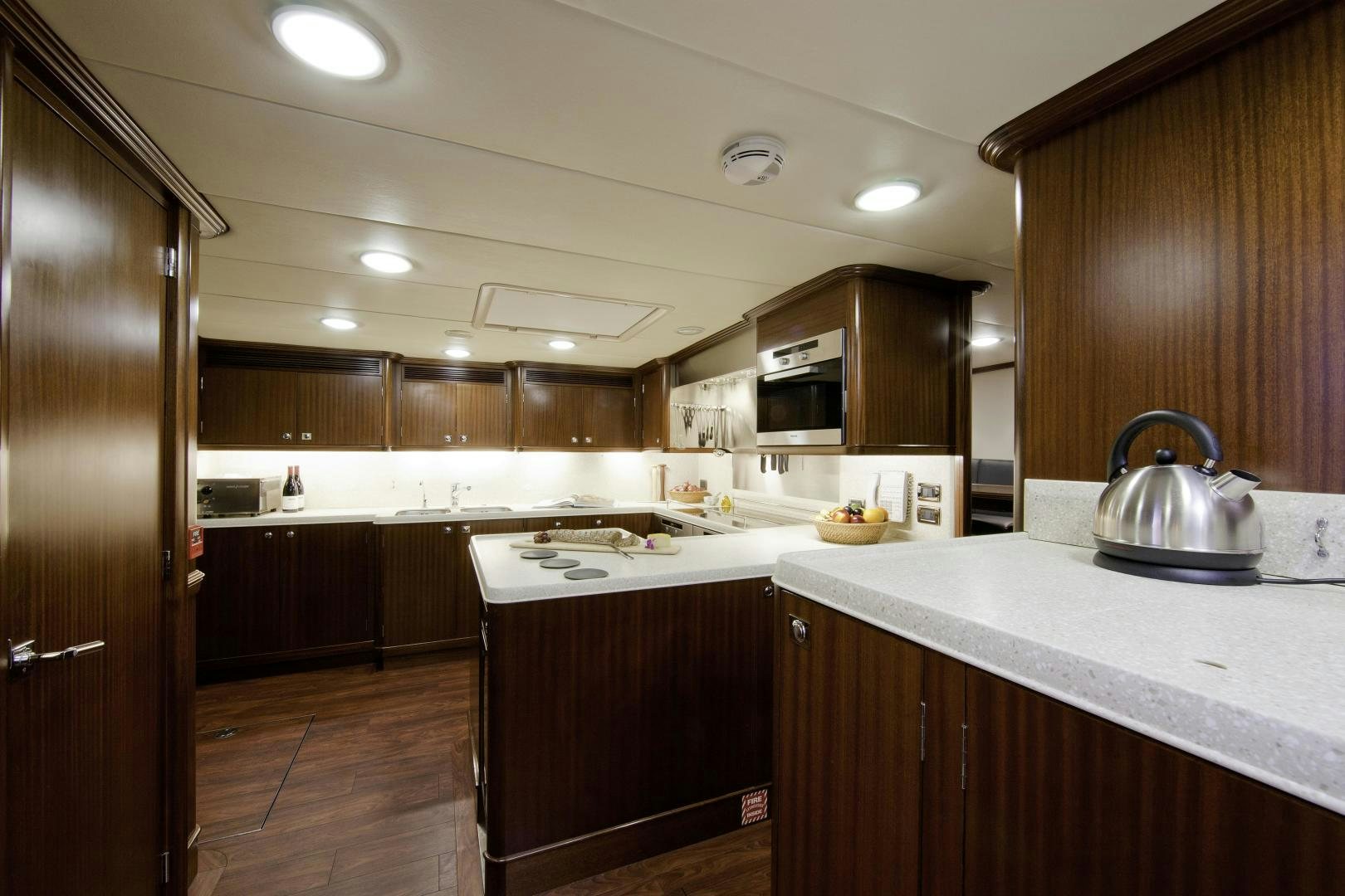 a kitchen with wooden cabinets aboard DESTINATION Yacht for Sale