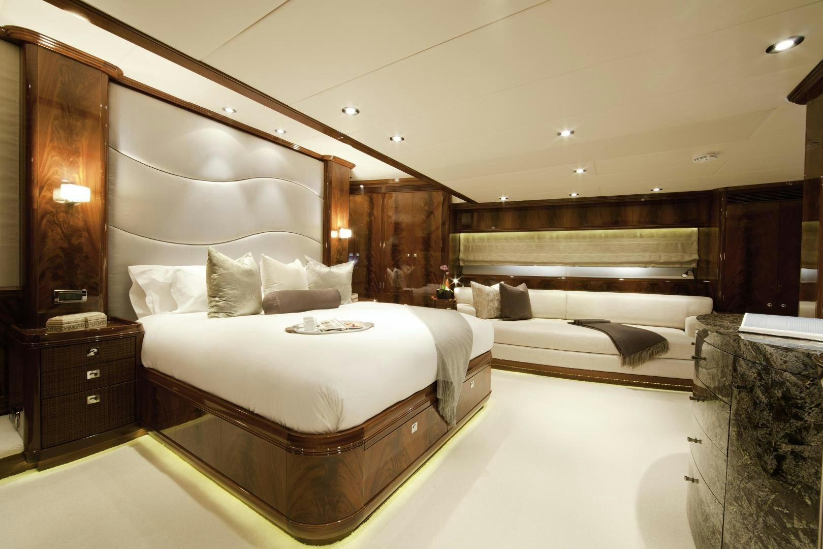 a room with a bed and a couch aboard DESTINATION Yacht for Sale