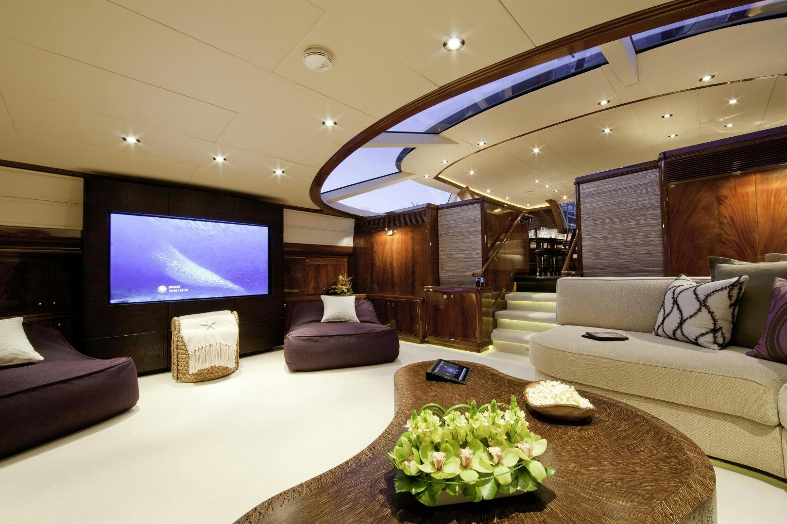 a living room with a large screen aboard DESTINATION Yacht for Sale