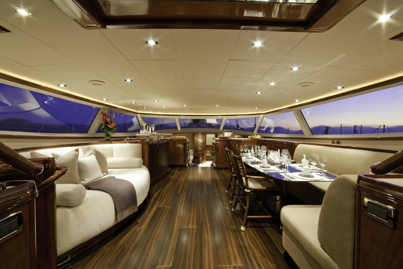 a room with a wood floor and a large screen with a table and chairs and a large white aboard DESTINATION Yacht for Sale