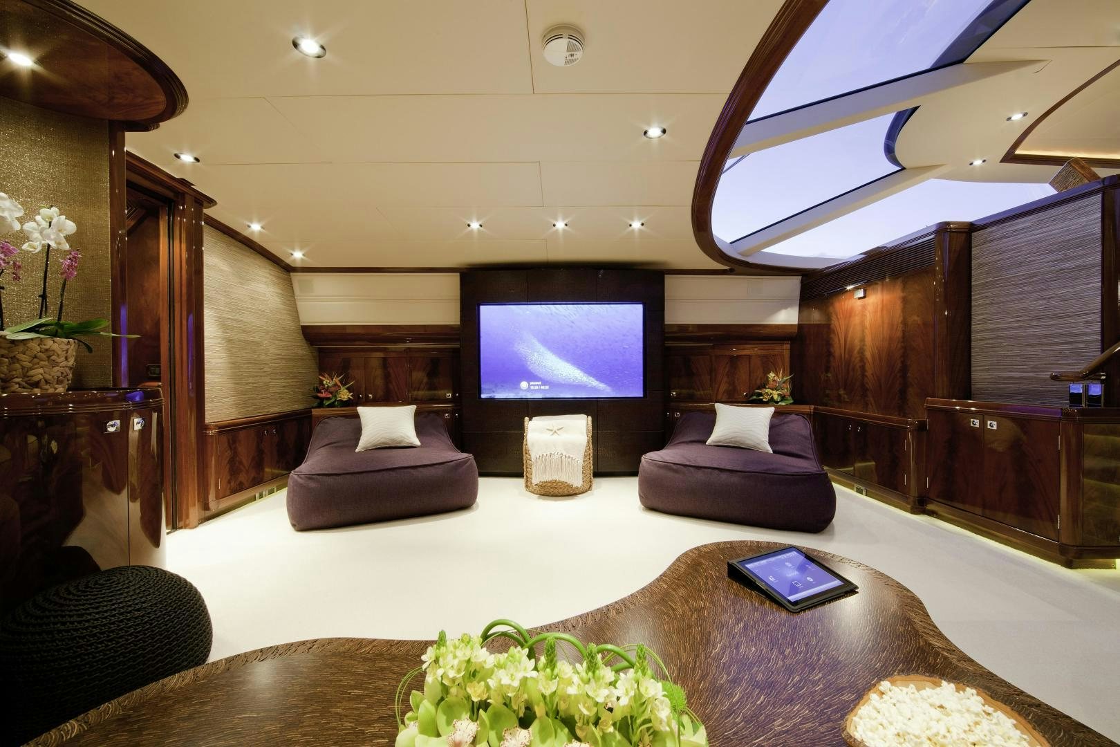 a living room with a tv and furniture aboard DESTINATION Yacht for Sale