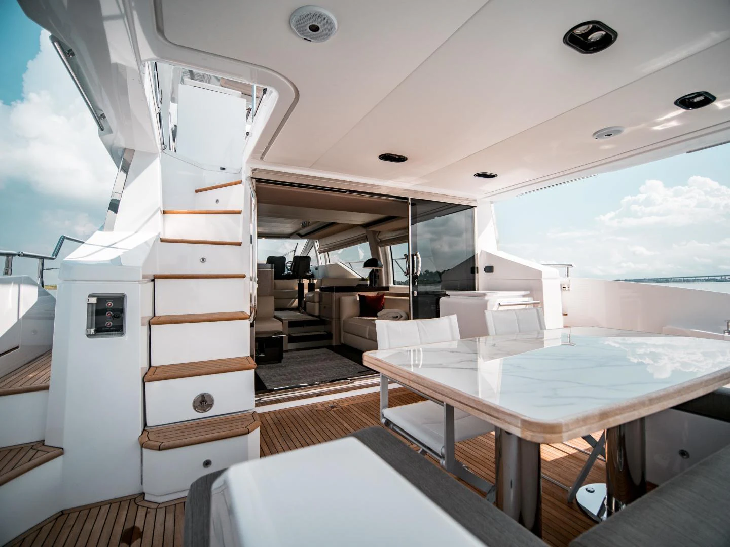 a boat with a desk and a table and chairs aboard EVADO Yacht for Sale