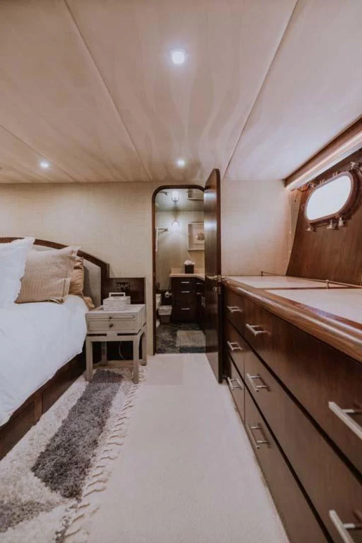 a bedroom with a large mirror aboard SUP Yacht for Sale