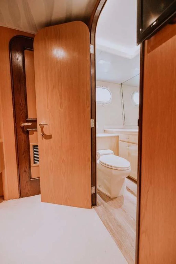 a bathroom with a wood door aboard SUP Yacht for Sale