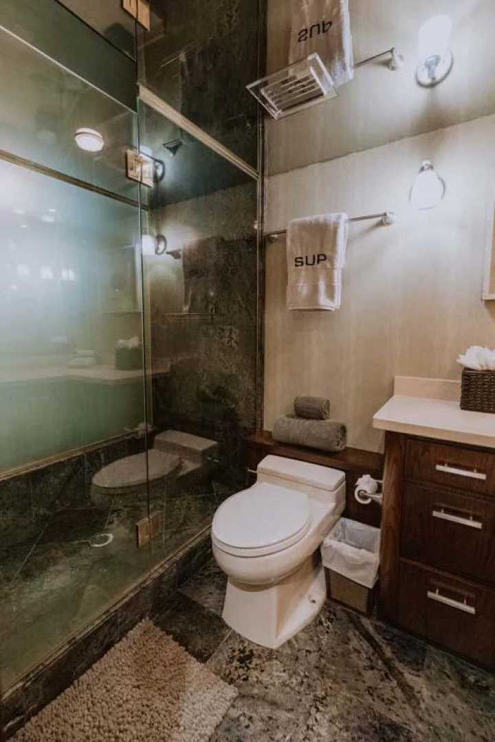 a bathroom with a glass shower aboard SUP Yacht for Sale