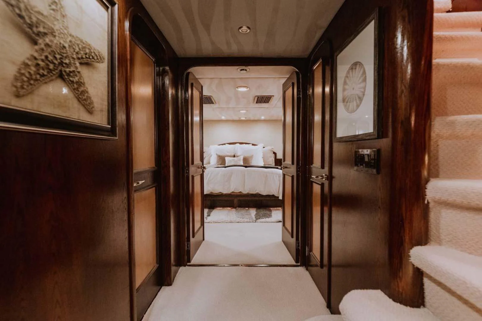 a room with a bed and a mirror aboard SUP Yacht for Sale