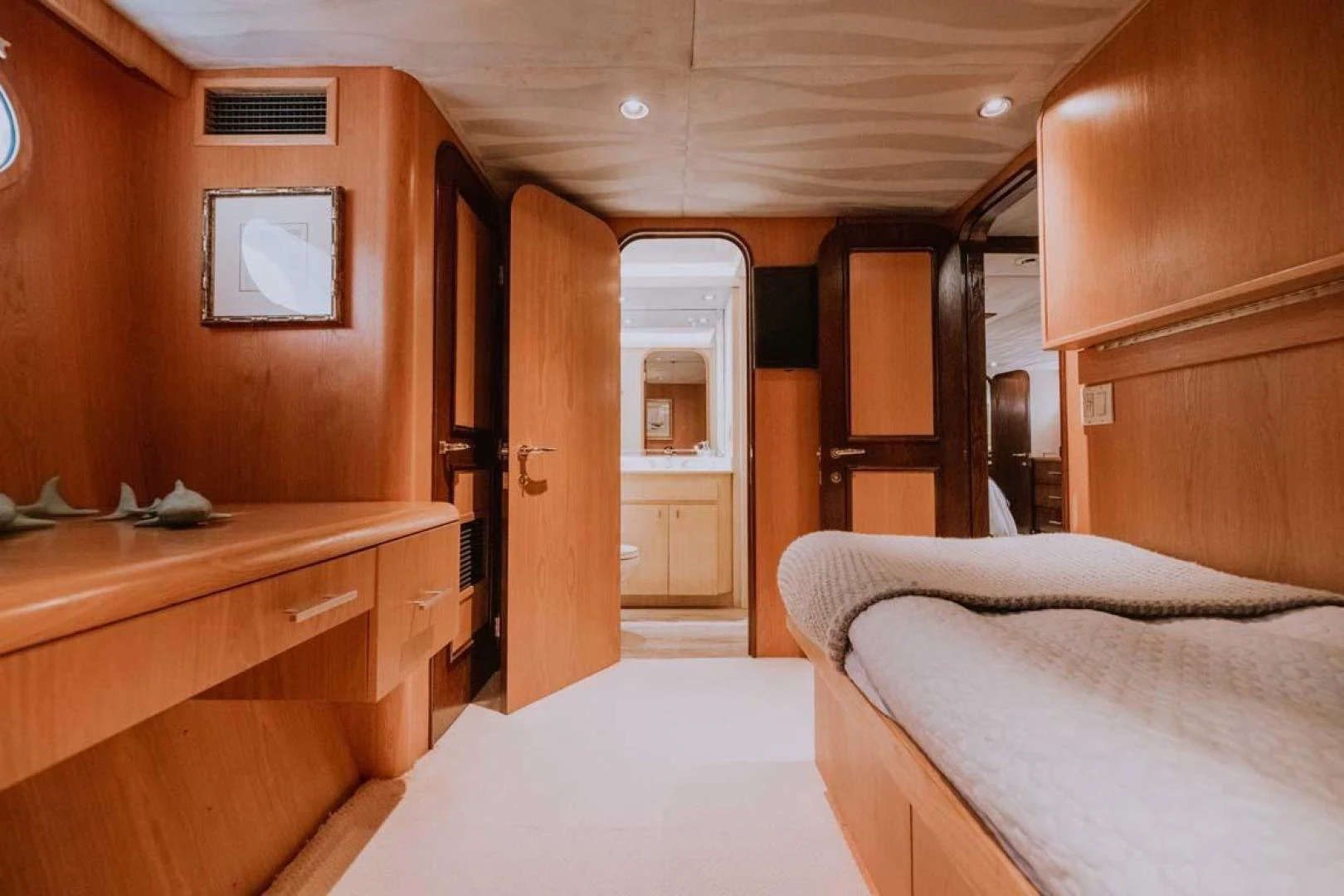 a room with a desk and a bed aboard SUP Yacht for Sale