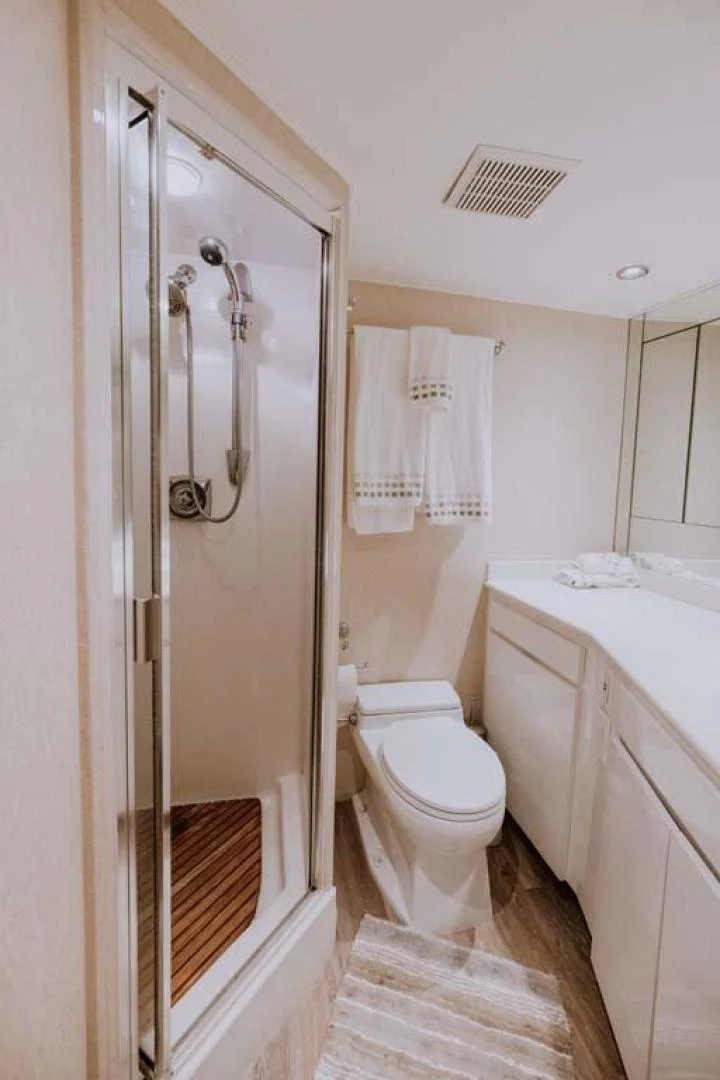 a bathroom with a shower and toilet aboard SUP Yacht for Sale