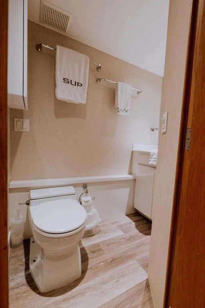 a bathroom with a toilet and a sink aboard SUP Yacht for Sale
