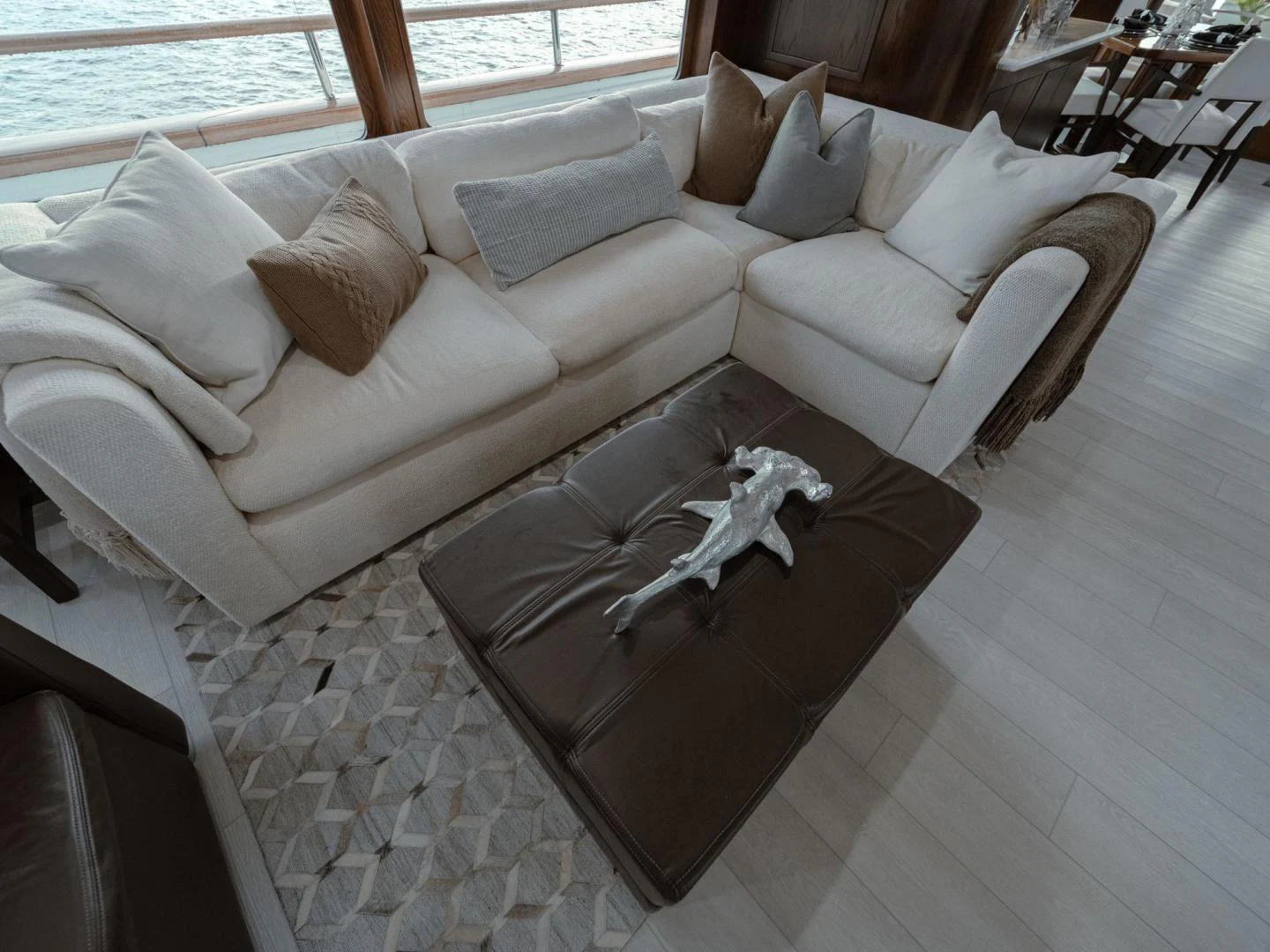 a couch with a pillow and a chair in a room aboard SUP Yacht for Sale