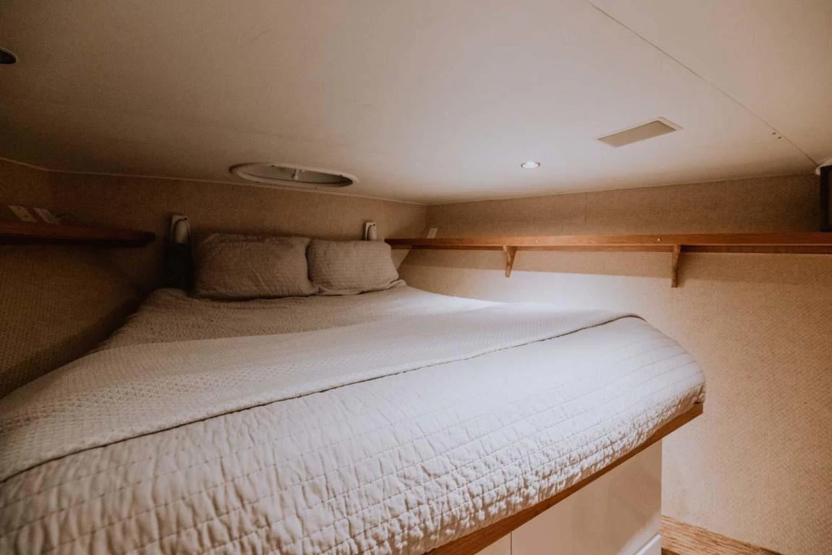 a bed with white sheets aboard SUP Yacht for Sale