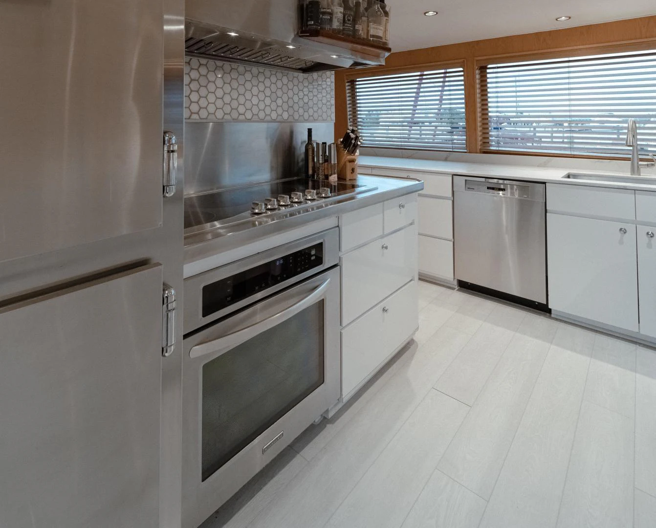 a kitchen with white cabinets aboard SUP Yacht for Sale