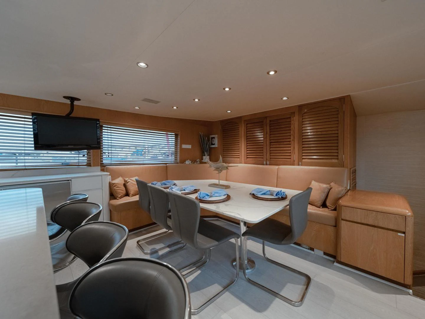 a living room with a table and chairs aboard SUP Yacht for Sale