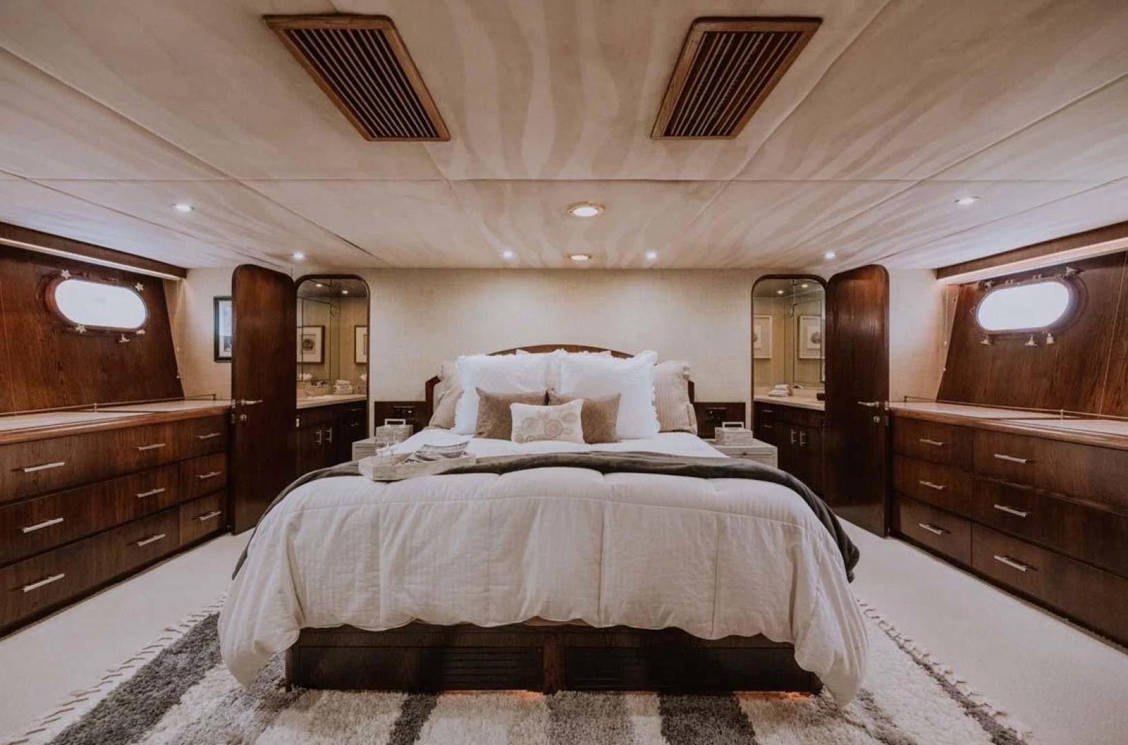 a bedroom with a bed and dresser aboard SUP Yacht for Sale