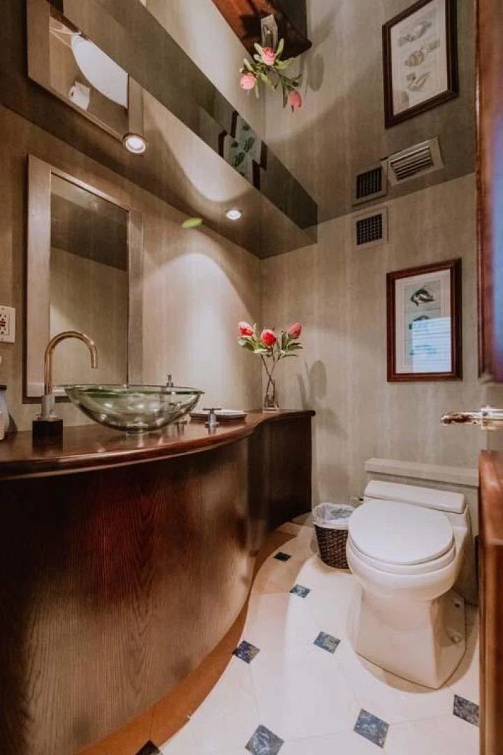 a bathroom with a sink toilet and a mirror aboard SUP Yacht for Sale