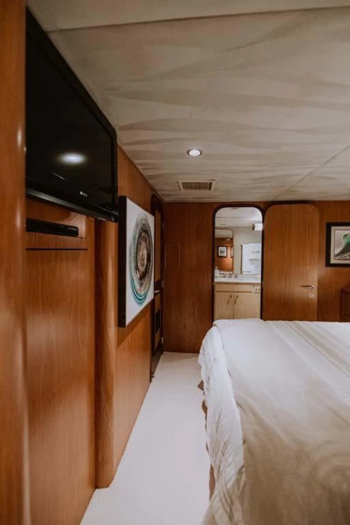 a bedroom with a bed and a television aboard SUP Yacht for Sale