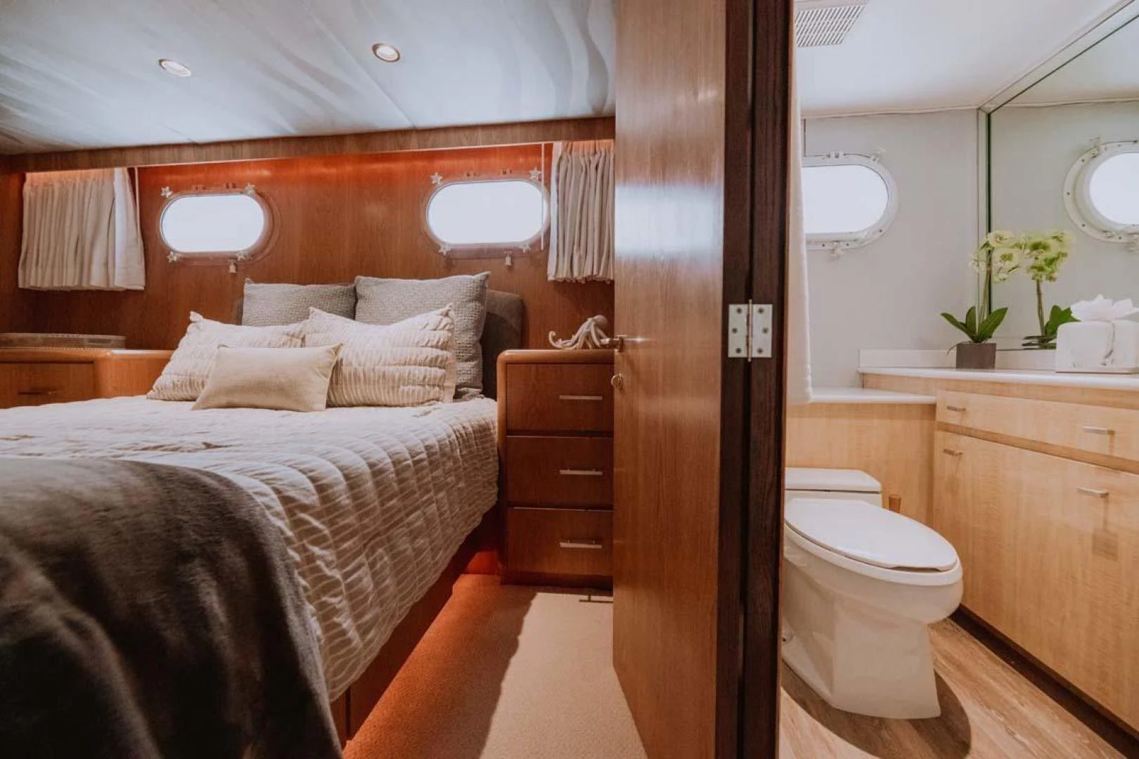 a bedroom with a bed and a mirror aboard SUP Yacht for Sale