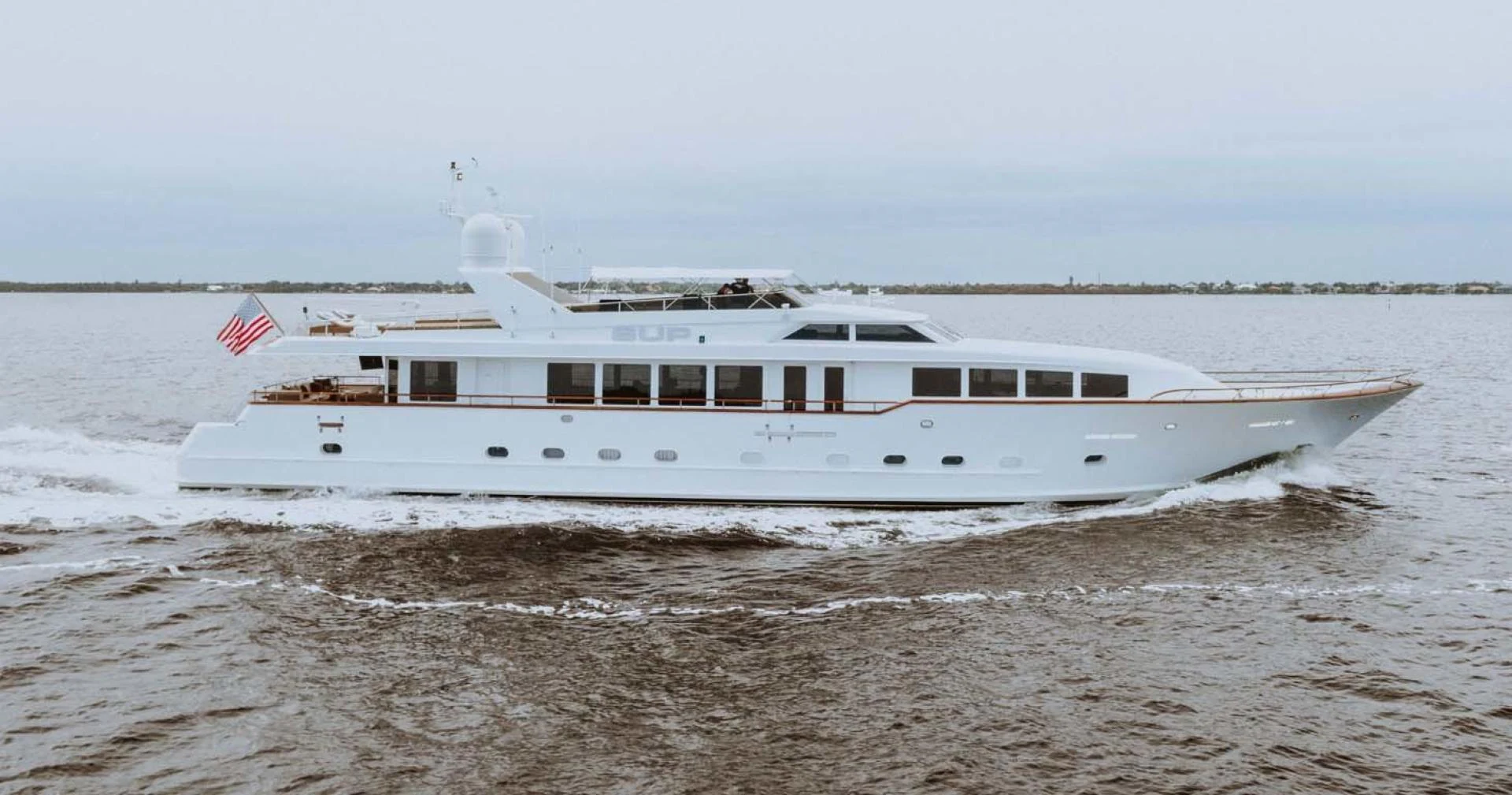a boat on the beach aboard SUP Yacht for Sale