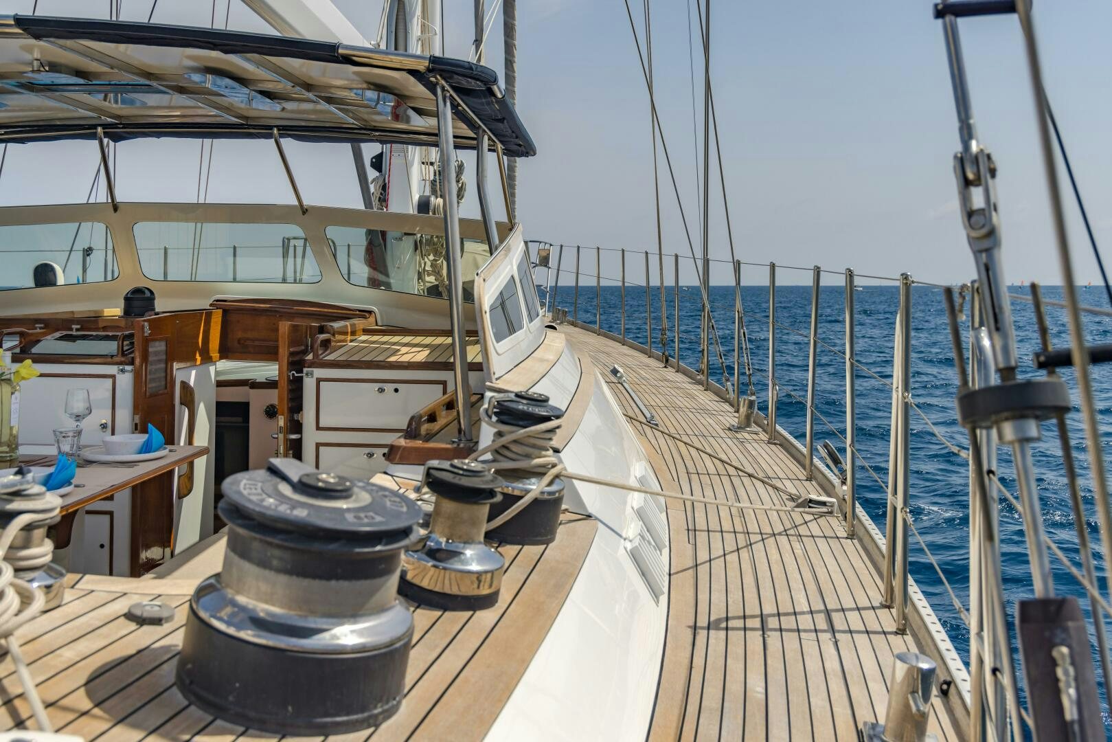 a deck with a deck and a large ship in the water aboard ALTAIR Yacht for Sale