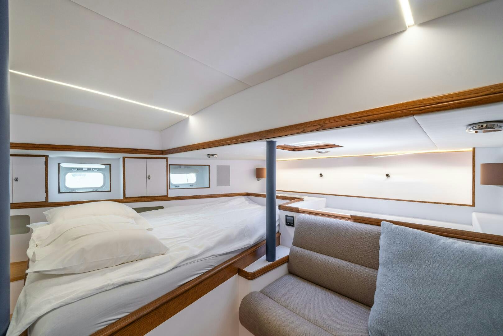 a bedroom with a bed and a couch aboard ALTAIR Yacht for Sale