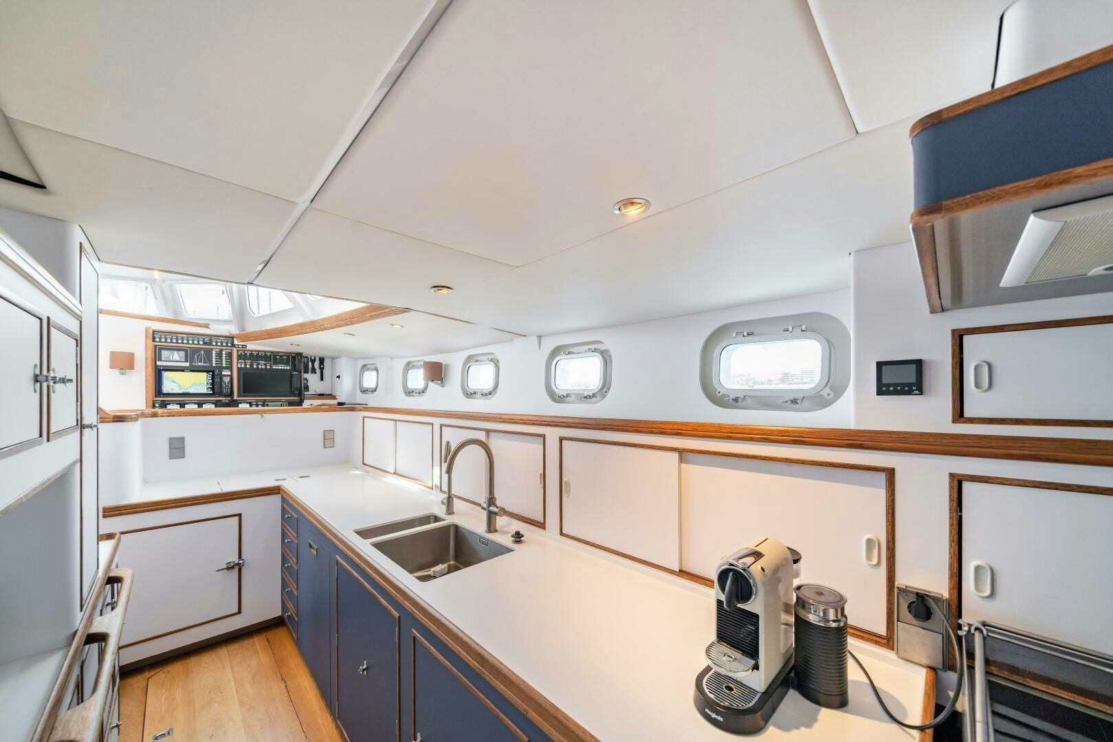 a kitchen with white cabinets aboard ALTAIR Yacht for Sale