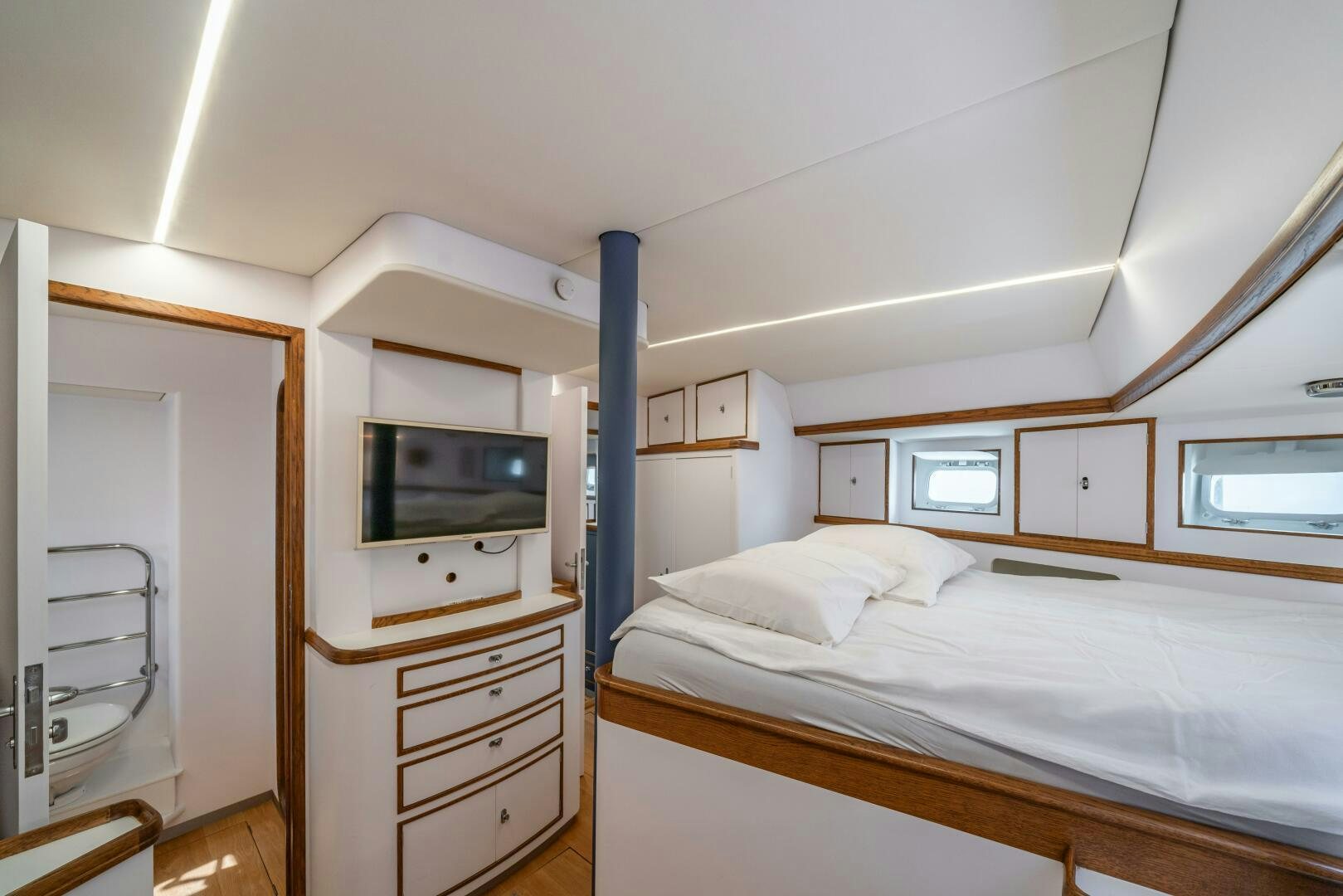 a bedroom with a bed and a television aboard ALTAIR Yacht for Sale