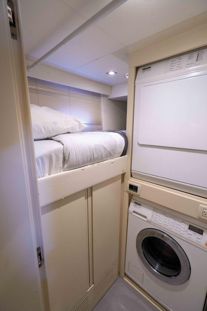 a small room with a washing machine aboard VIXEN Yacht for Sale