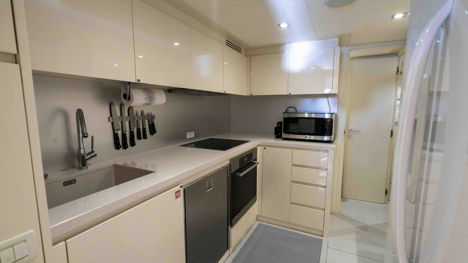 a kitchen with white cabinets aboard VIXEN Yacht for Sale