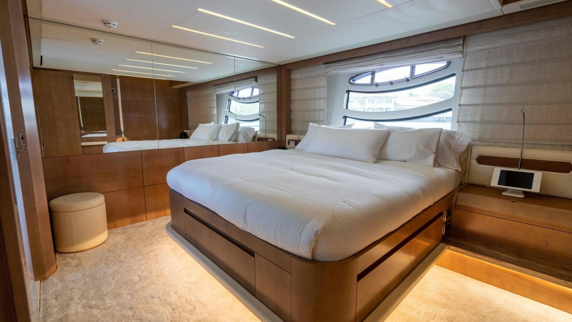 a room with a bed and a window aboard VIXEN Yacht for Sale