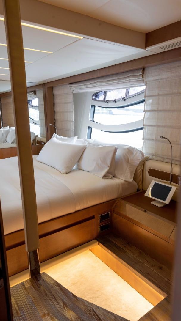 a bed with a laptop on it aboard VIXEN Yacht for Sale