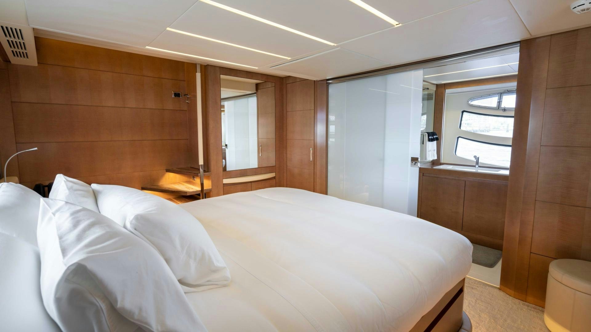 a room with a bed and a window aboard VIXEN Yacht for Sale