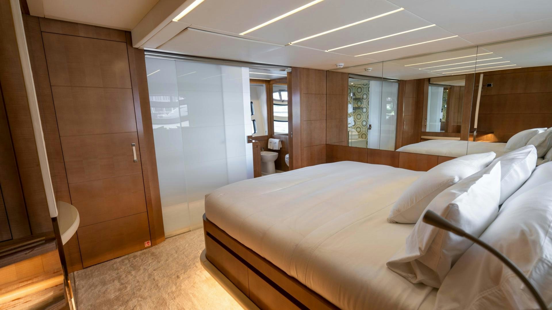 a room with a bed and a closet aboard VIXEN Yacht for Sale