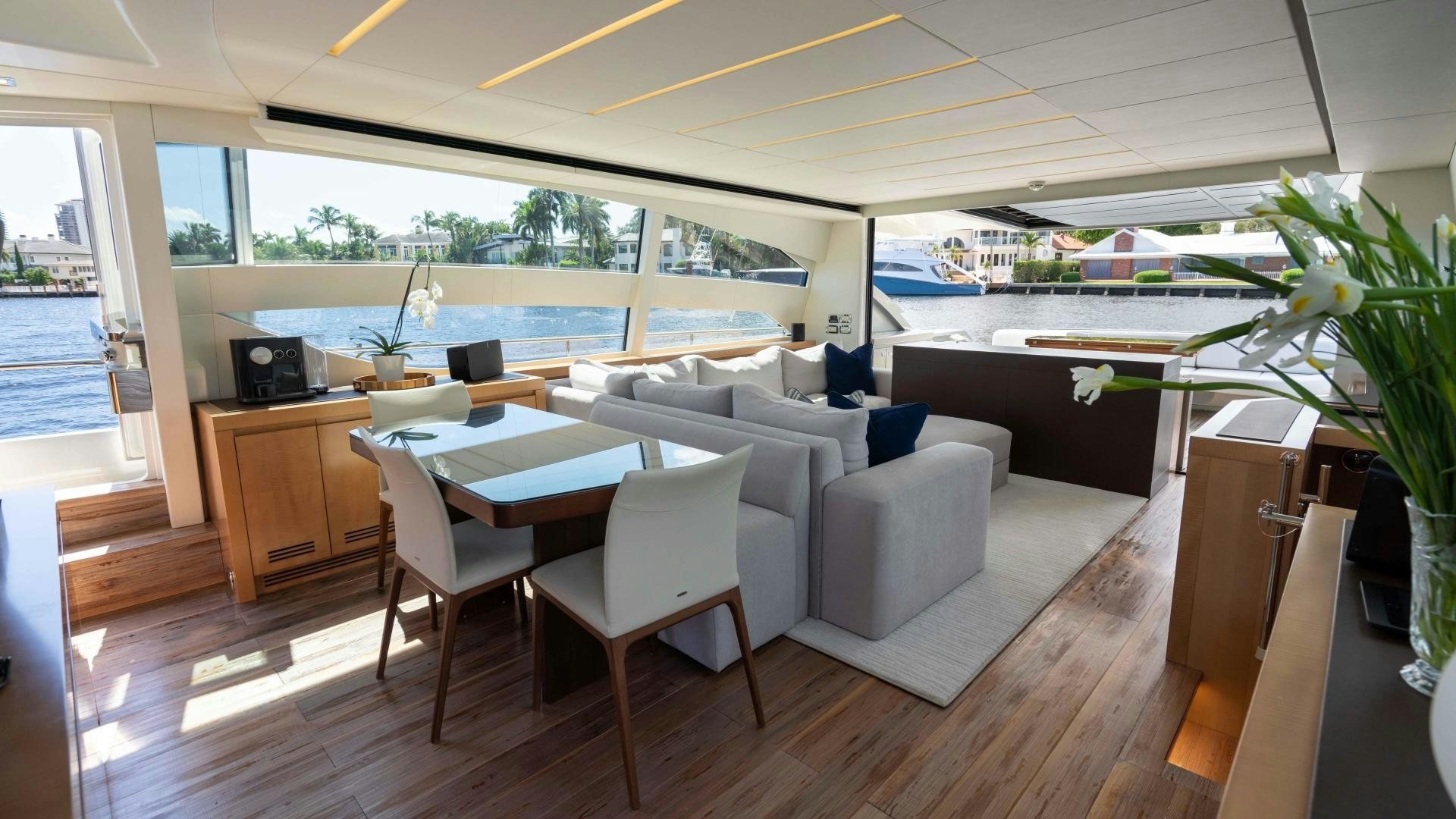 a room with a table chairs and plants aboard VIXEN Yacht for Sale