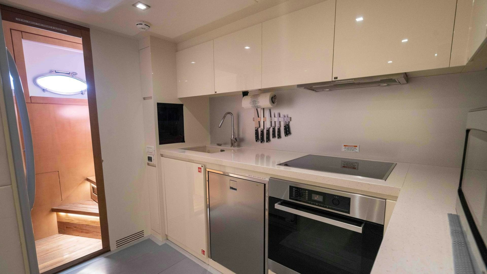 a kitchen with white cabinets aboard VIXEN Yacht for Sale