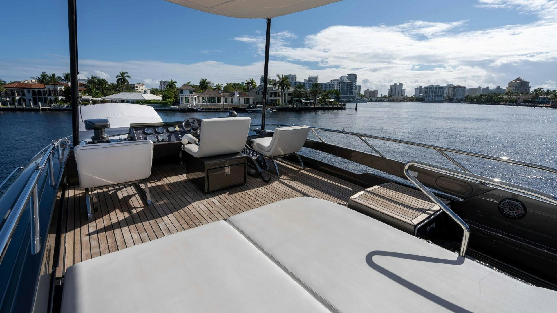 a deck with chairs and a table on it aboard VIXEN Yacht for Sale