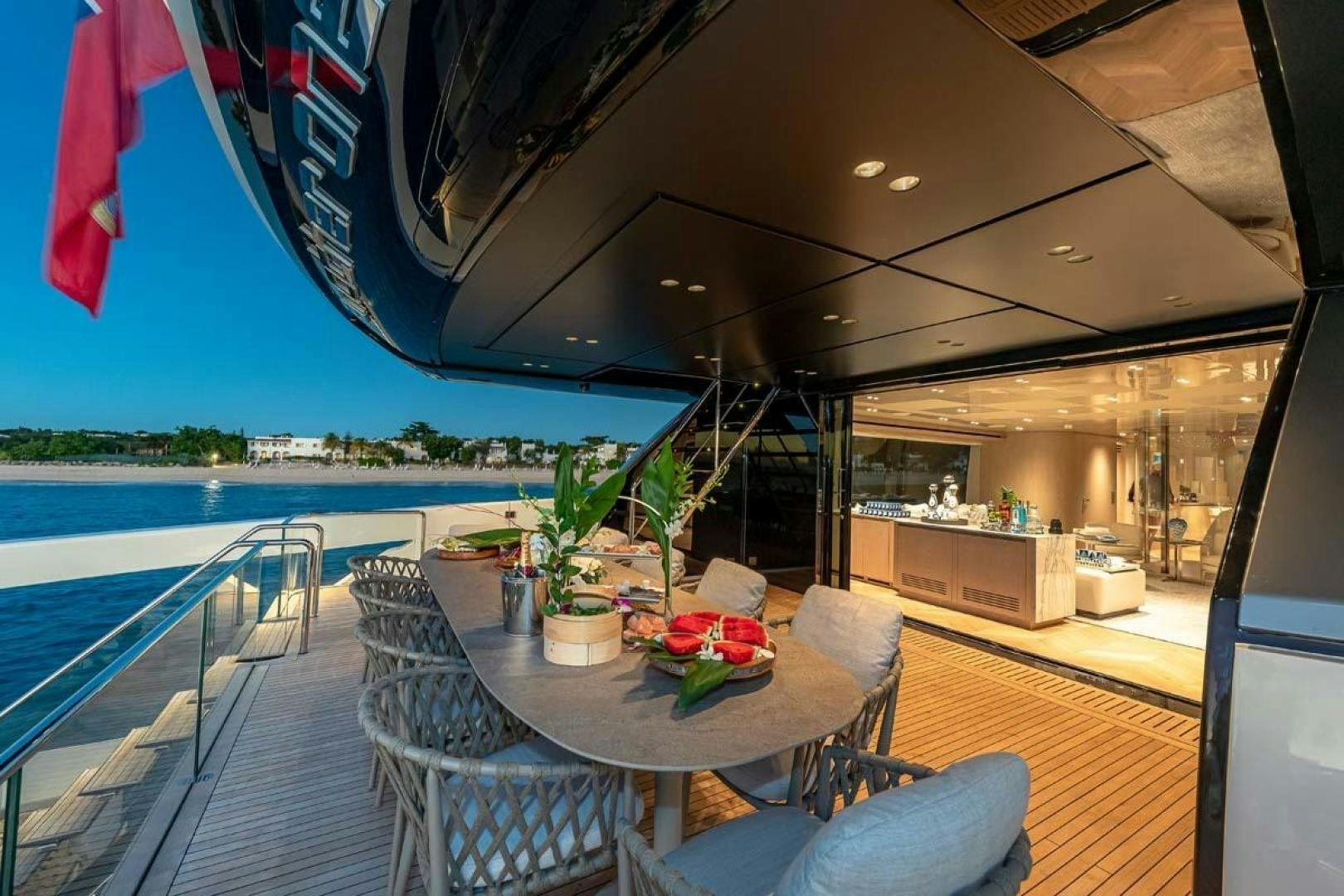 a table on a deck overlooking a body of water aboard ANOTHER ONE Yacht for Sale