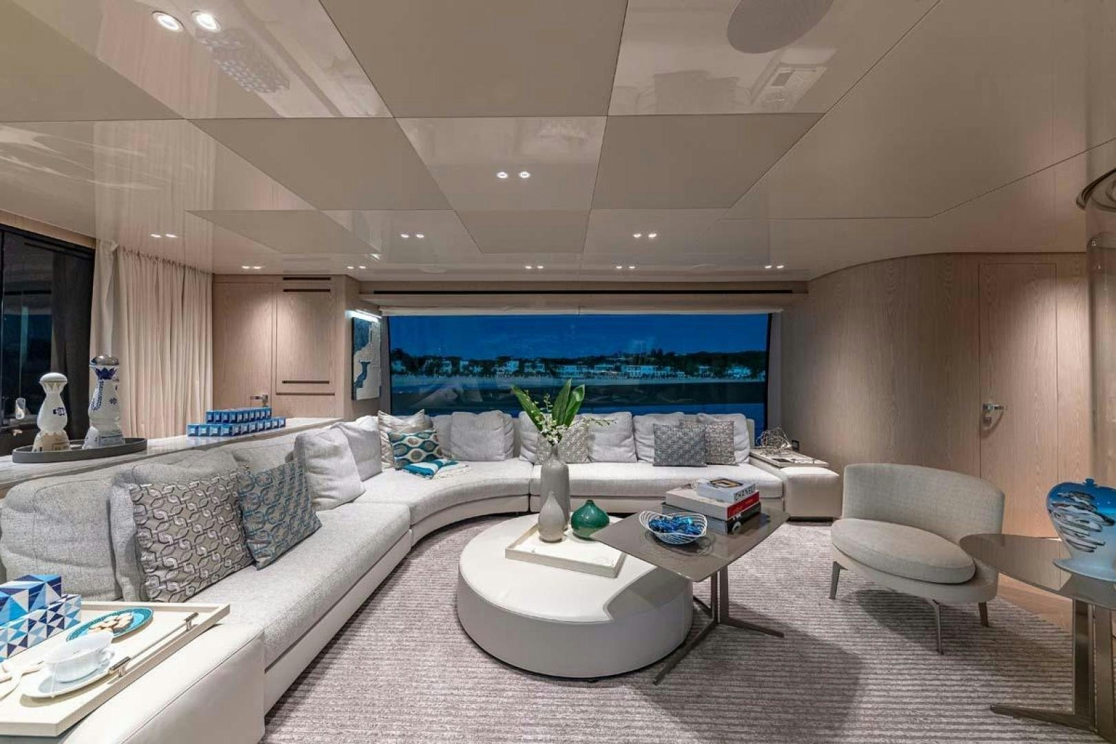 a living room with a large white sofa and a large screen aboard ANOTHER ONE Yacht for Sale