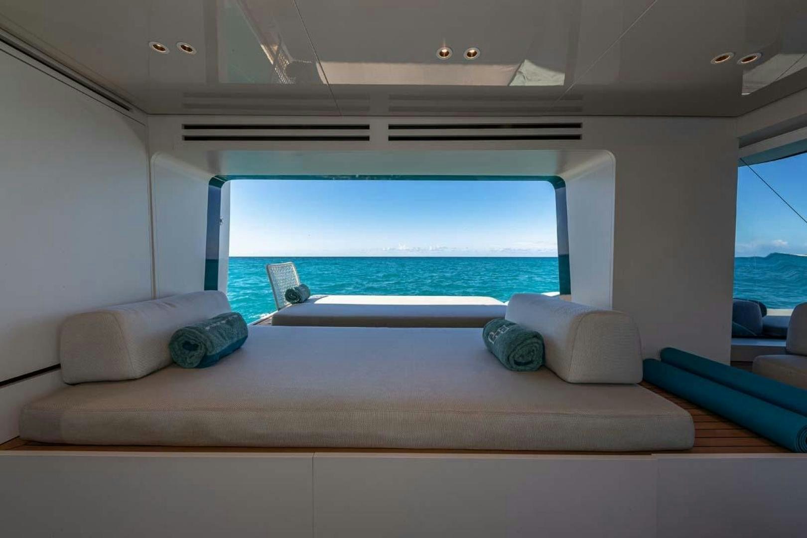 a room with a large window and a large blue pool aboard ANOTHER ONE Yacht for Sale