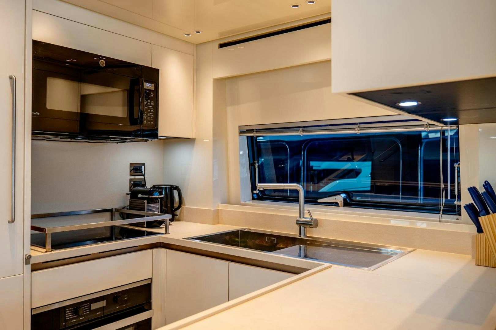 a kitchen with a large window aboard QUARANTENA Yacht for Sale