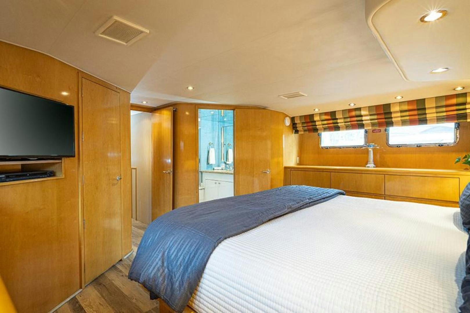a bedroom with a bed and tv aboard TUFF LIFE IV Yacht for Sale
