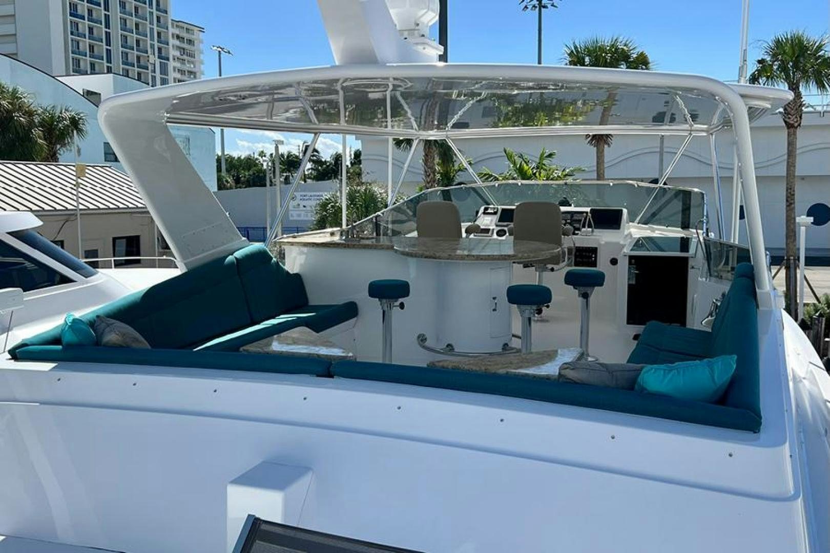 a white boat with chairs and tables aboard TUFF LIFE IV Yacht for Sale