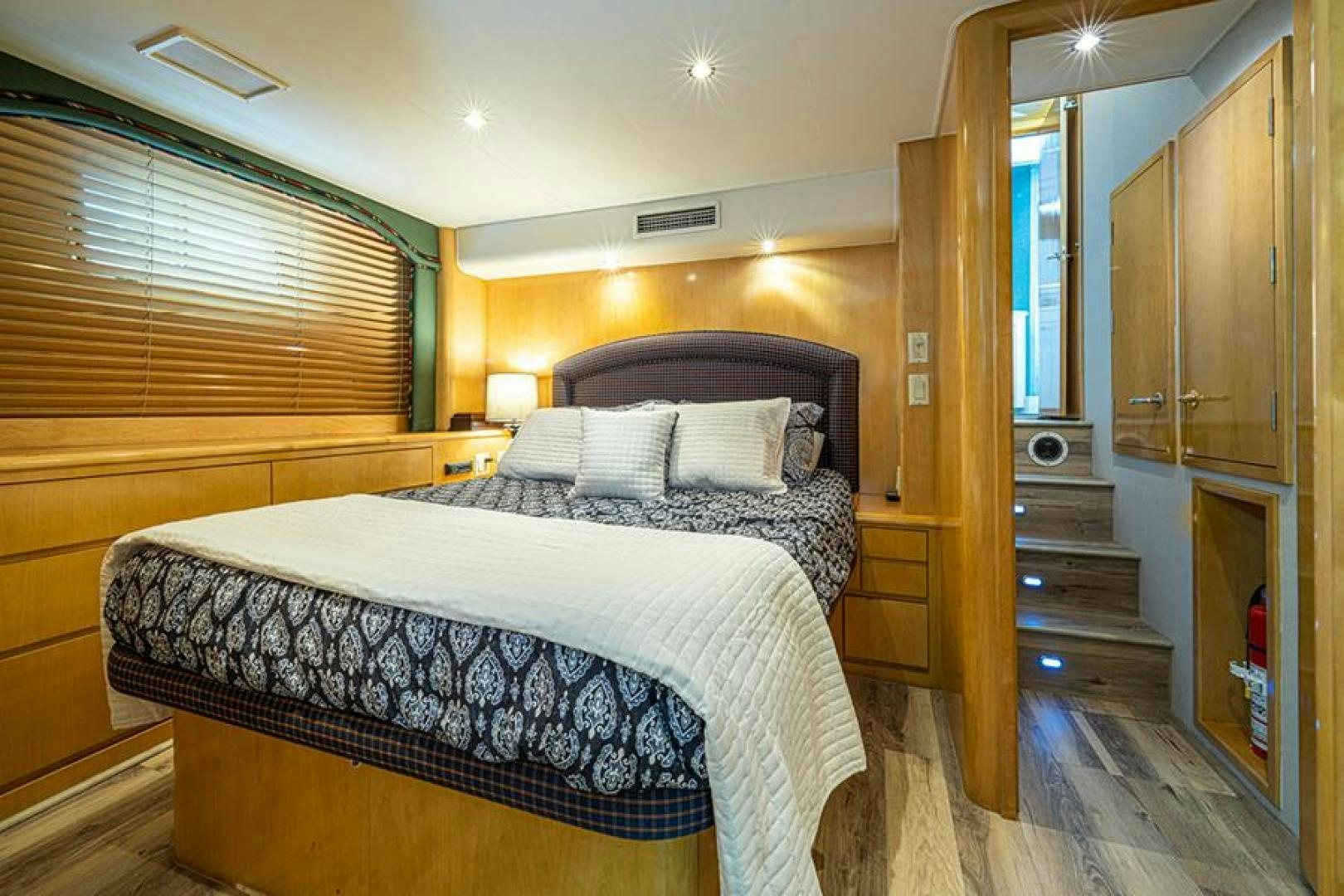 a bedroom with a bed and a closet aboard TUFF LIFE IV Yacht for Sale