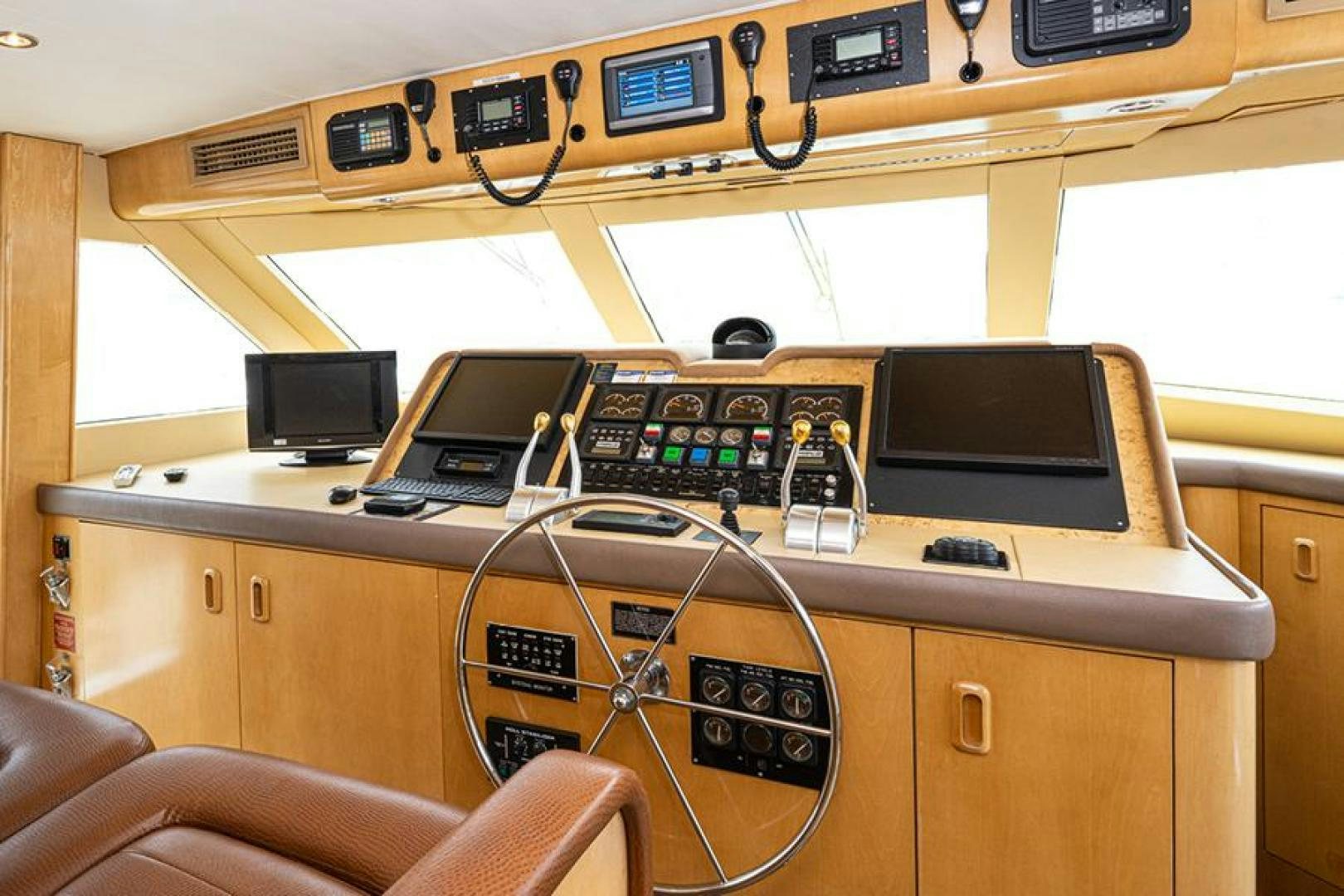 a control panel with a laptop and other electronic devices on it aboard TUFF LIFE IV Yacht for Sale