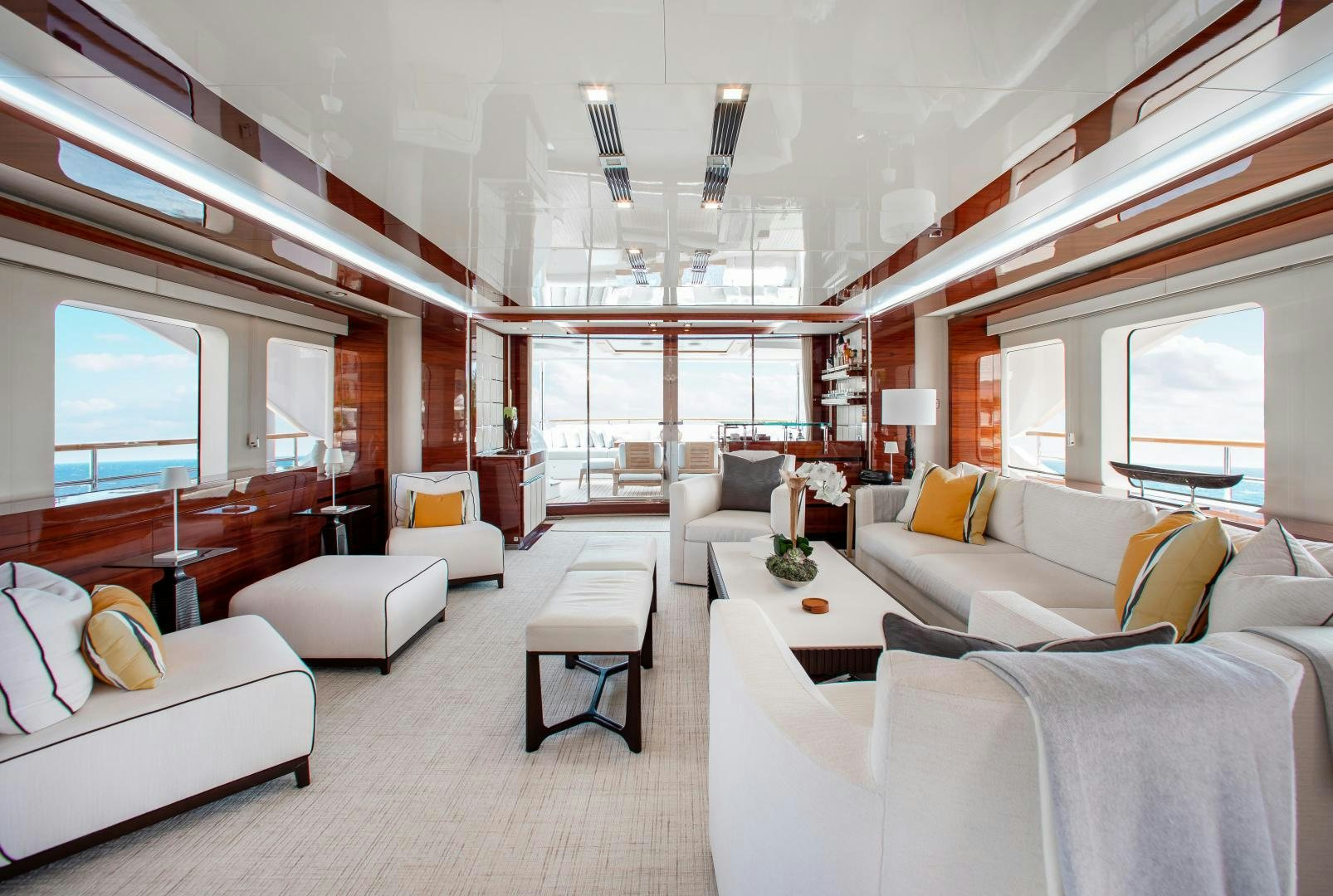 a room with white couches and a large window aboard ALLORA Yacht for Sale