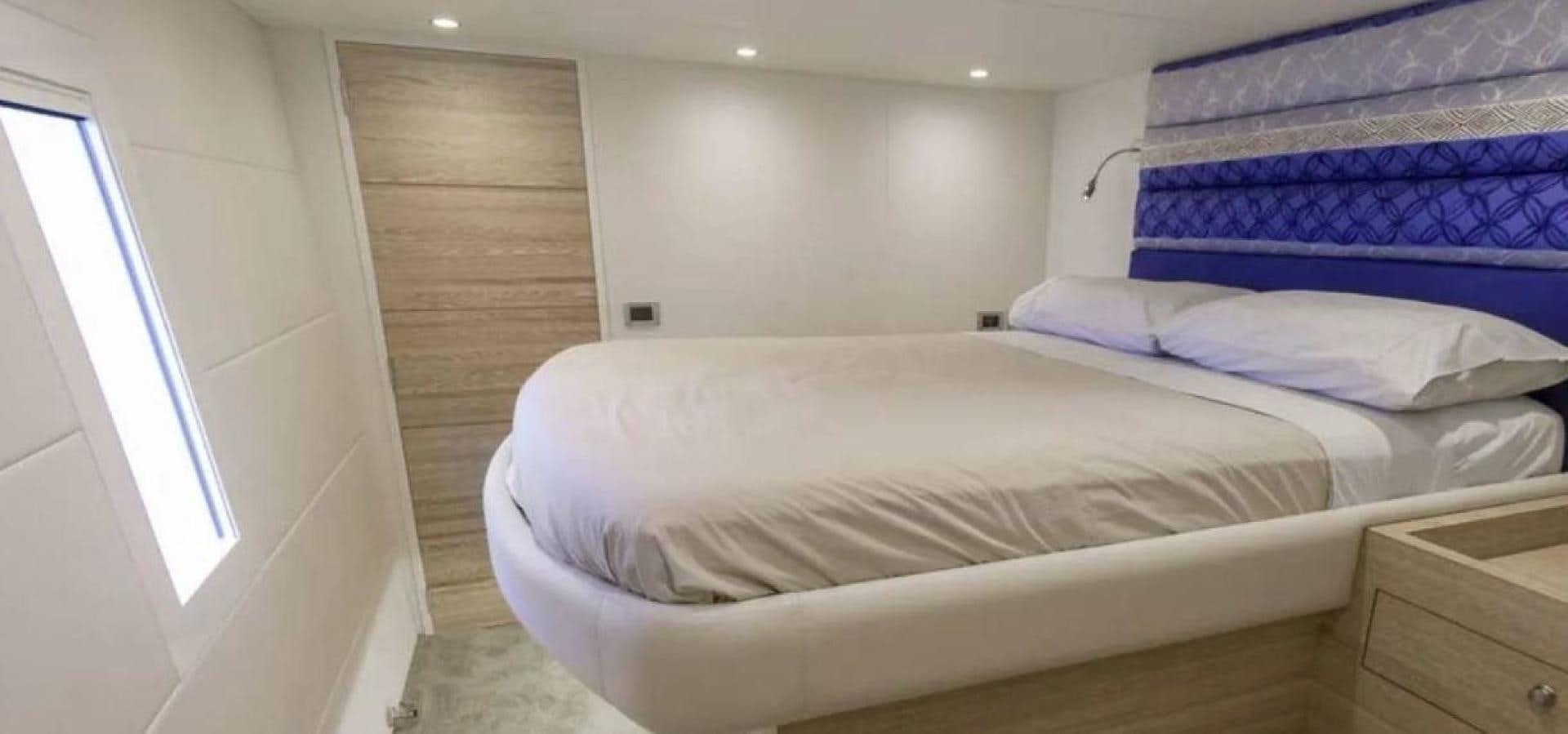 a bed with white sheets aboard SAMARA Yacht for Sale