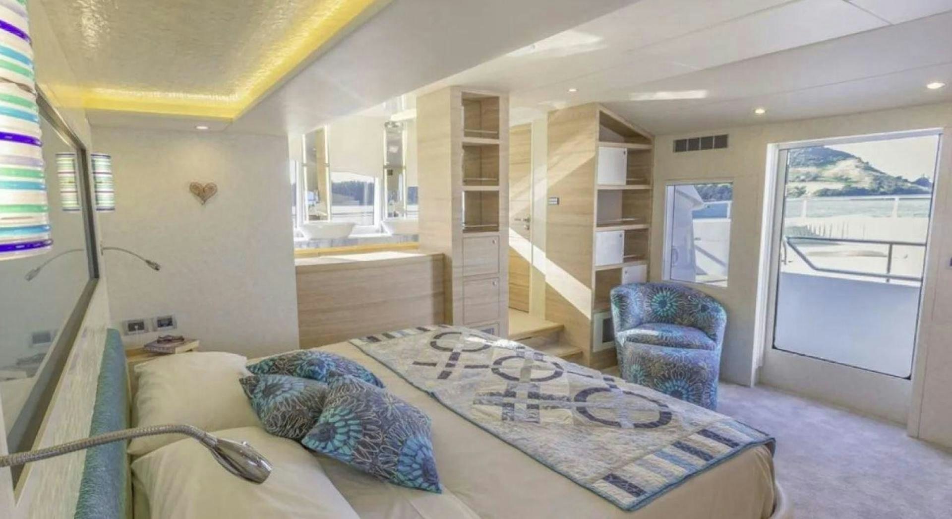 a bedroom with a bed and a bookcase aboard SAMARA Yacht for Sale