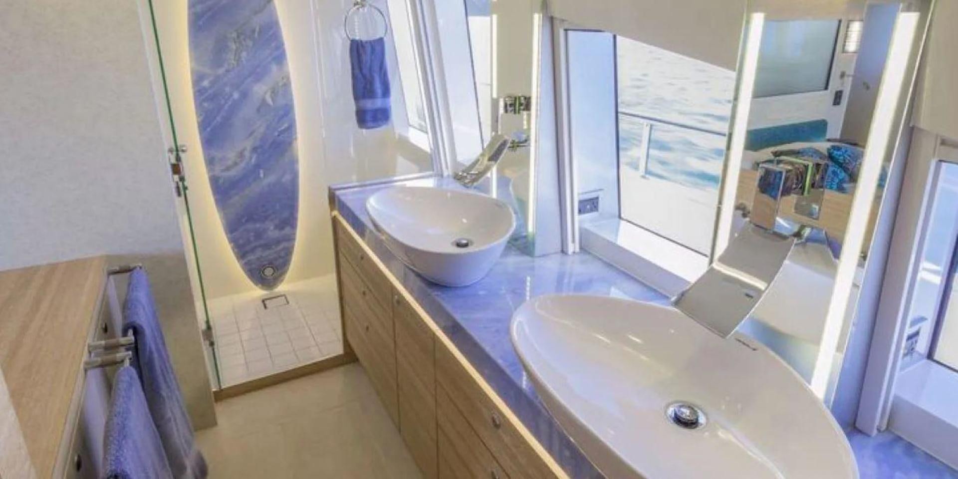 a bathroom with a sink and a large mirror aboard SAMARA Yacht for Sale